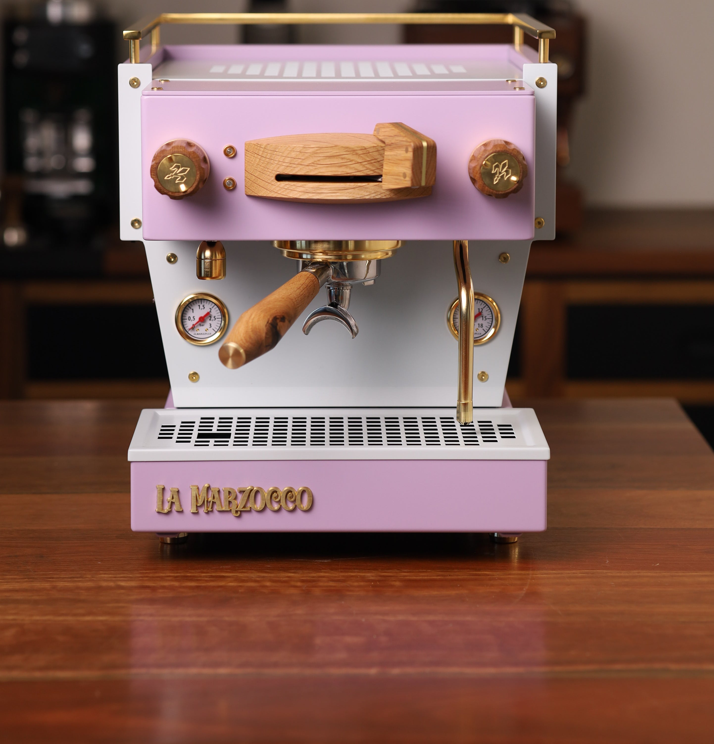 A bespoke, pink Linea Mini espresso machine with oak and brass-gold highlights, by Specht. We call it the Sugarplum.