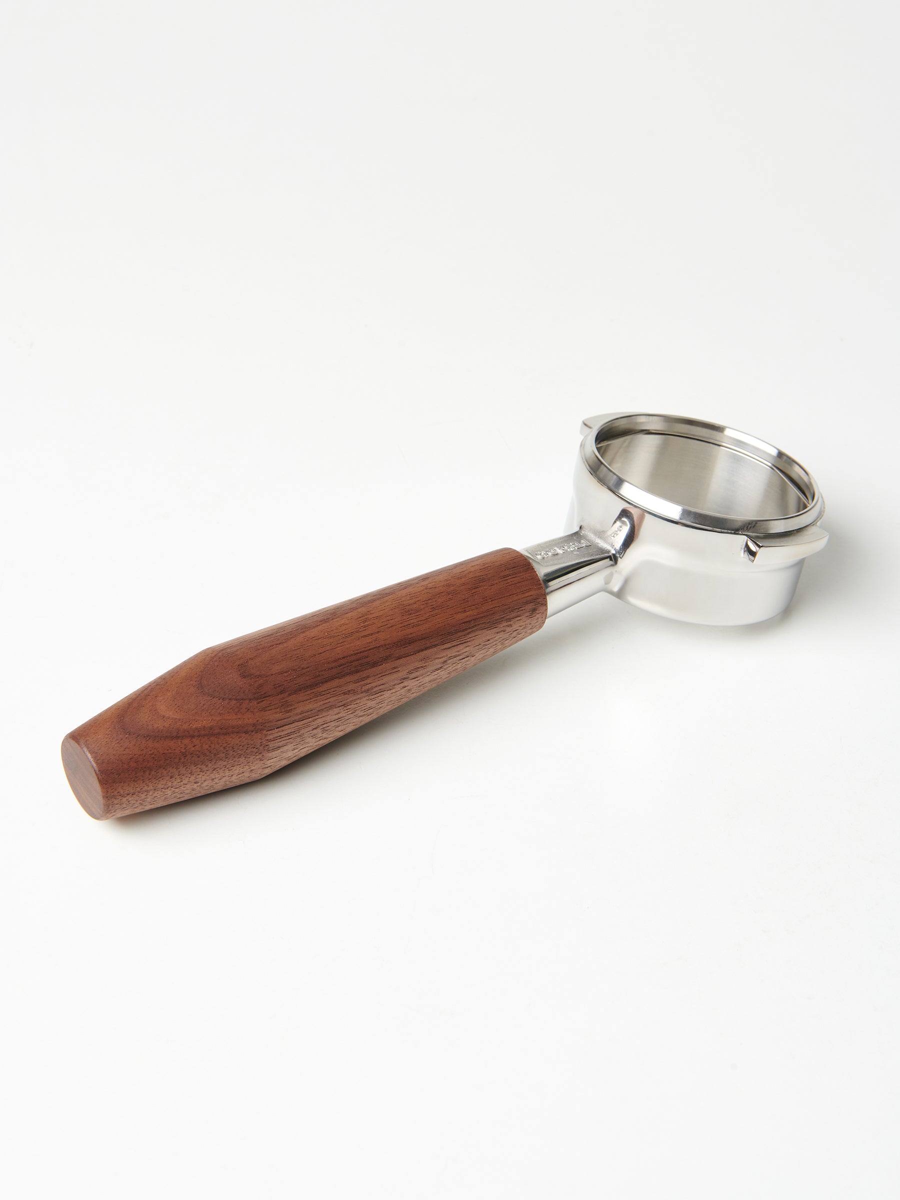A bottomless Pesado portafilter with a dark walnut handle.