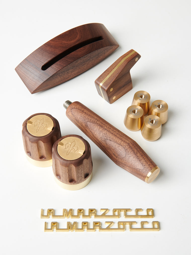 A dark walnut and polished brass La Marzocco Linea Mini Wood Kit by Specht 