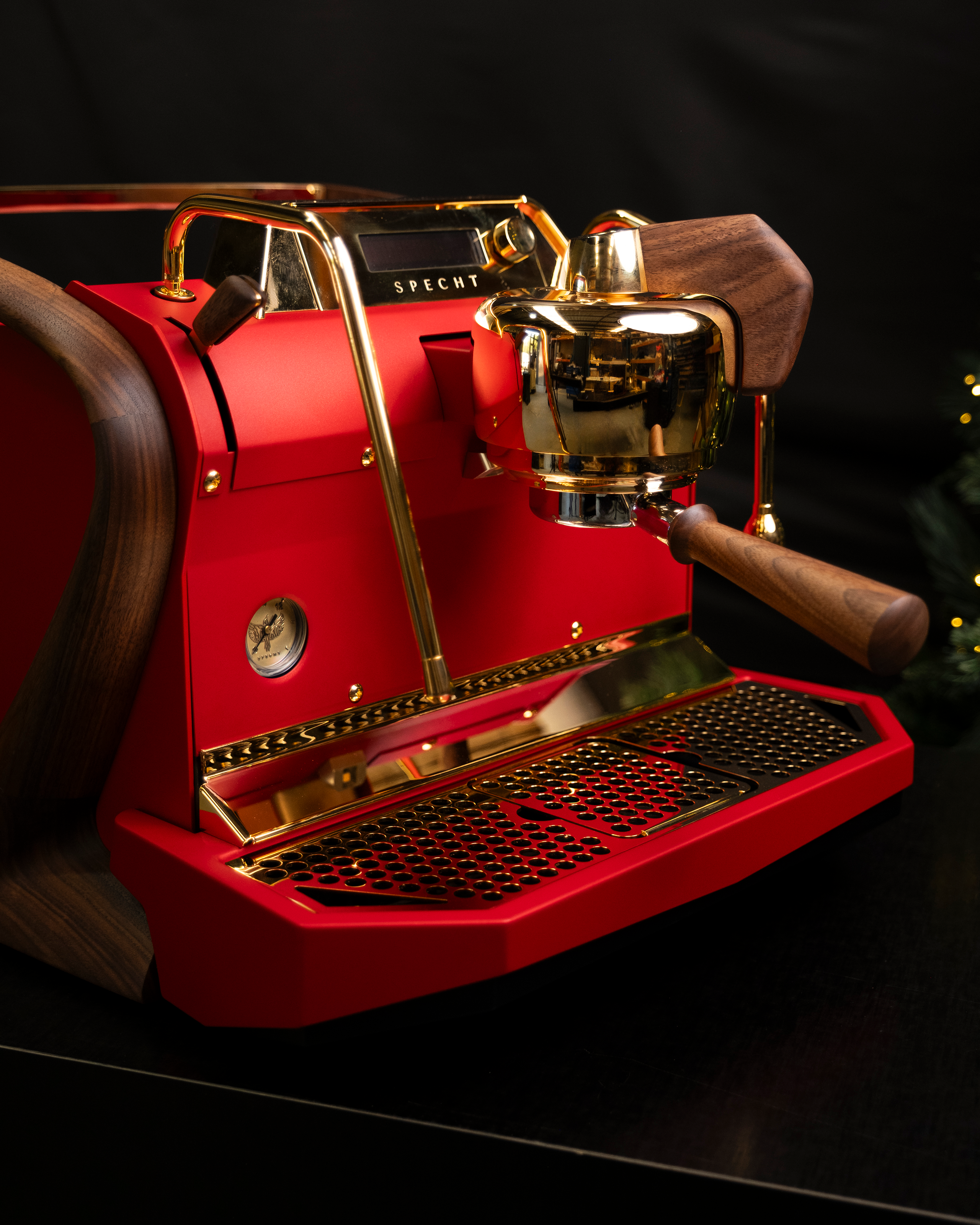 A red Slayer Steam Single espresso machine, with gold plating and walnut touchpoints.