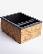 A wooden, oak Specht knock box for coffee grounds disposal.