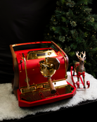 A red, gold-plated Slayer Steam Single espresso machine with walnut legs, reimagined by Specht.