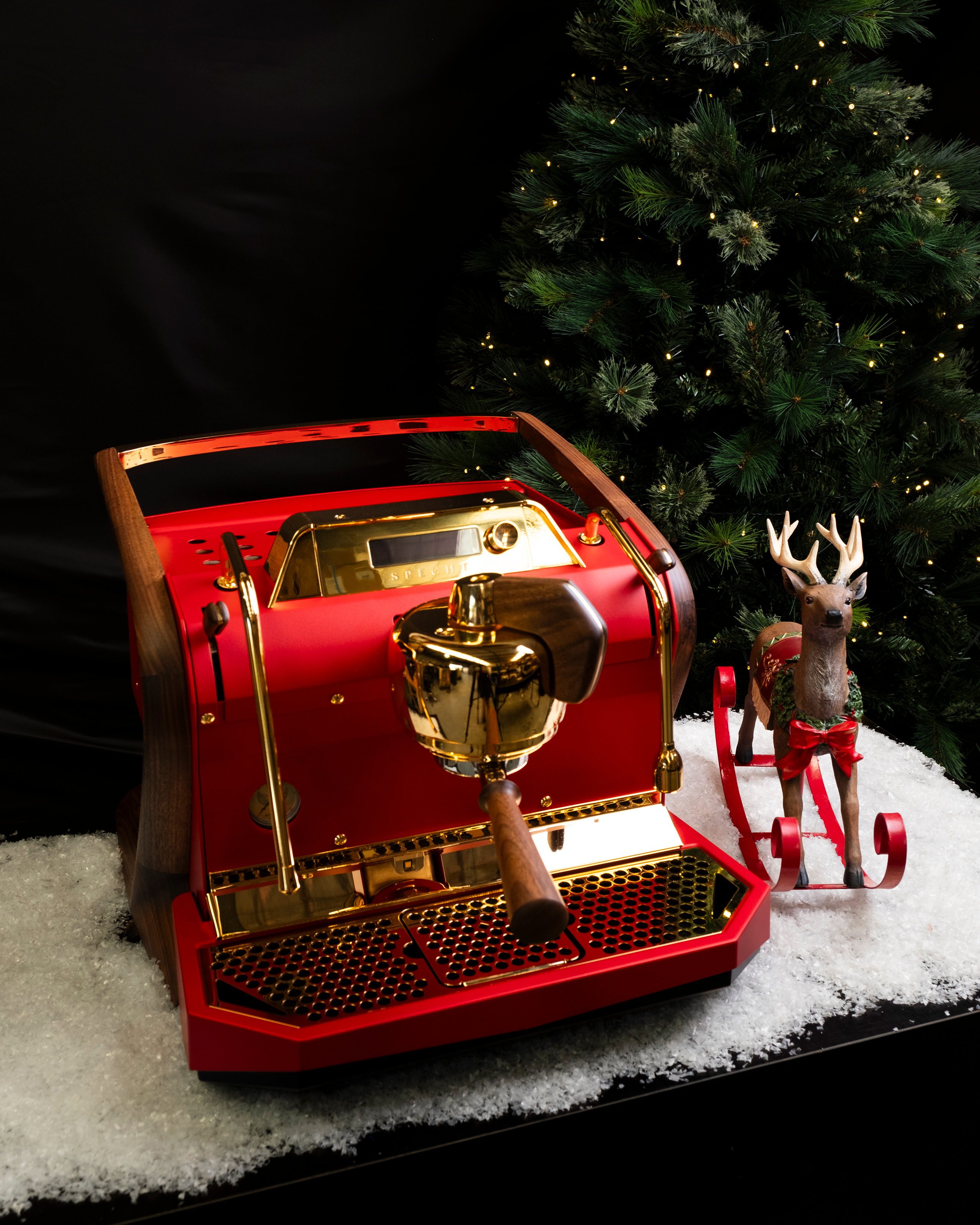 A red, gold-plated Slayer Steam Single espresso machine with walnut legs, reimagined by Specht.
