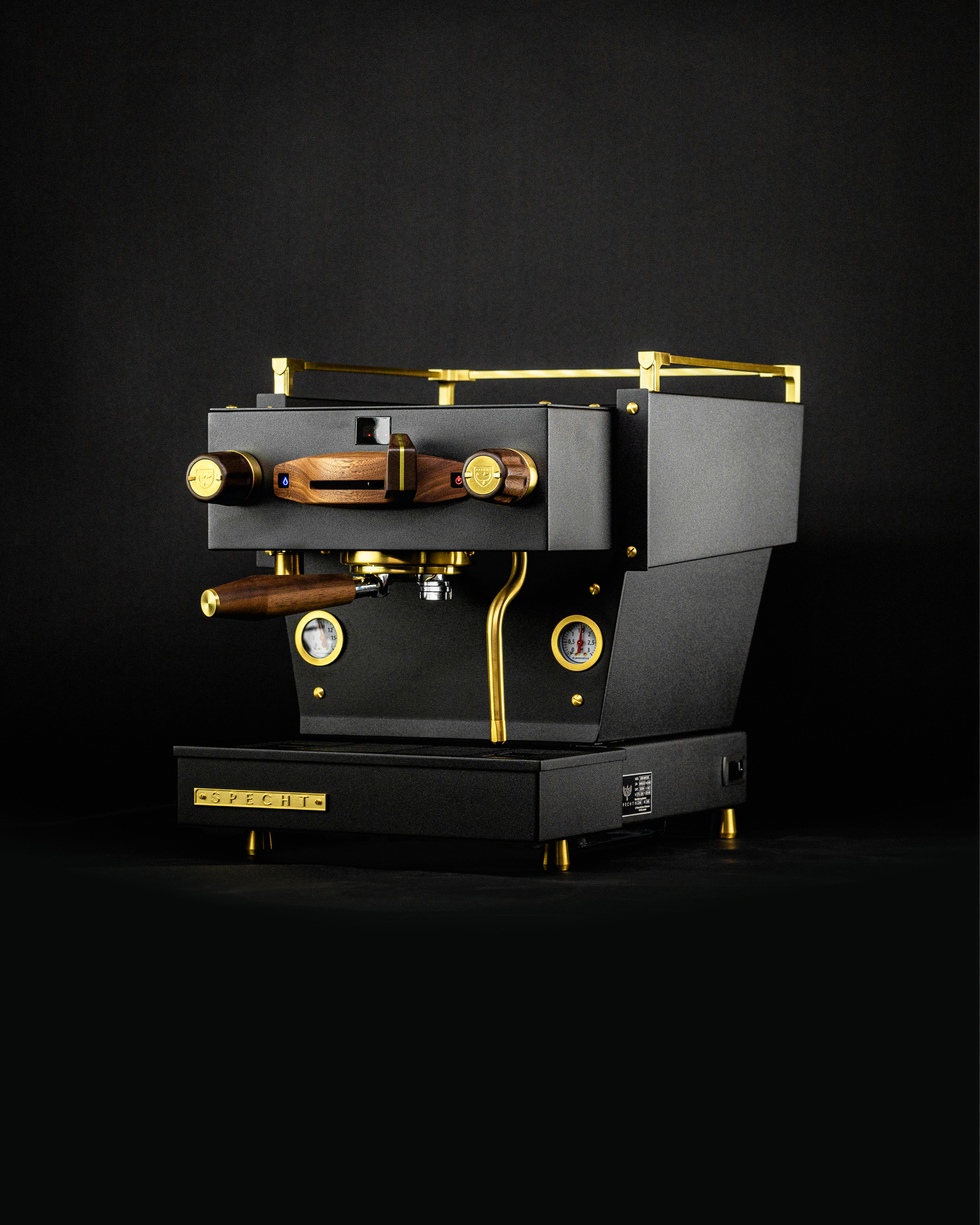 A bespoke black Linea Mini home espresso machine by Specht, with gold highlights and walnut touchpoints.