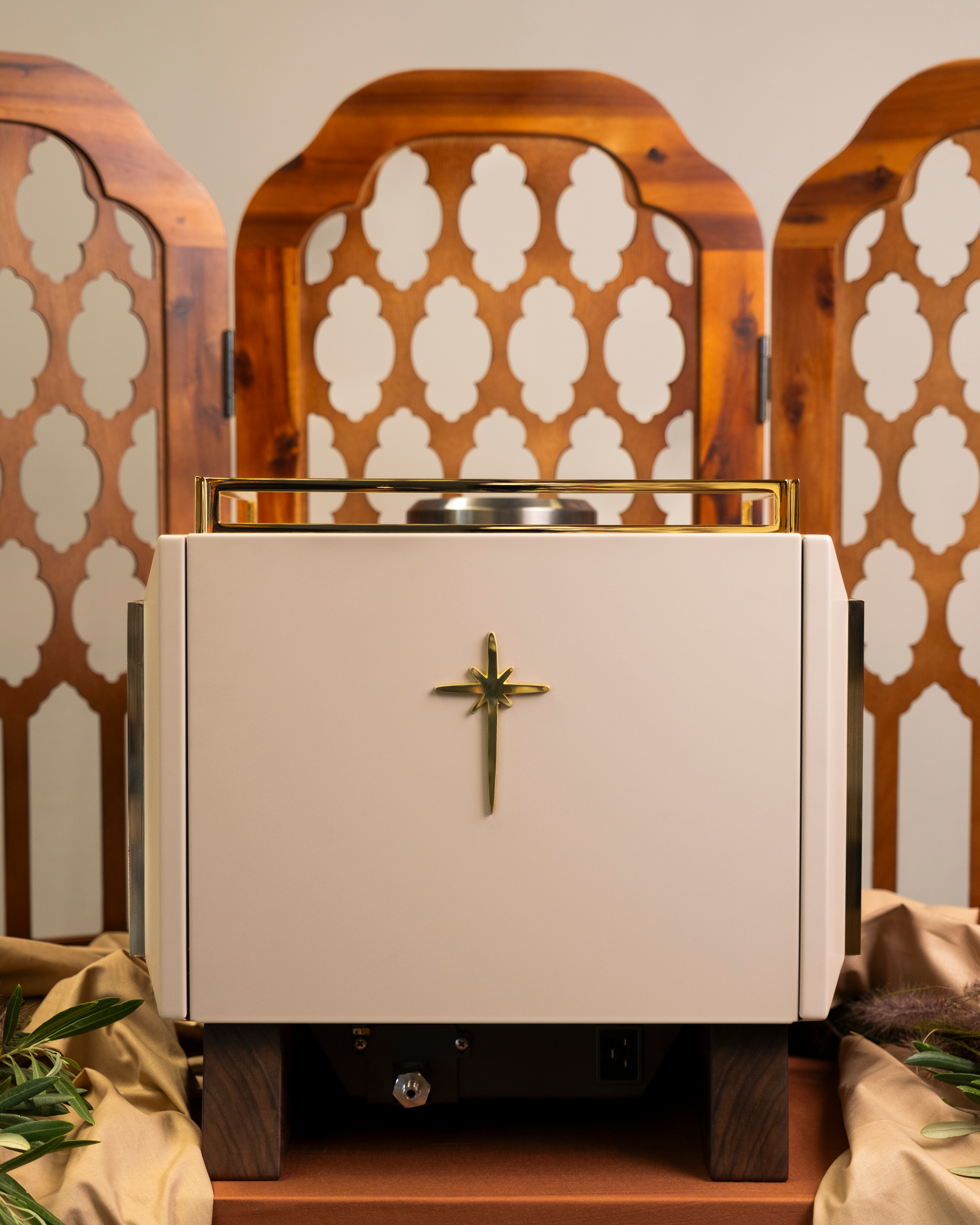 The back of a Rocket Bicocca home espresso machine, reimagined by Specht with pure 24-carat gold detailing, a light body, and transparent amber-fluted glass sides. A tall start badge features prominently. 