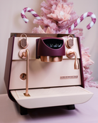 A luxurious pink and burgundy Eagle One Prima EXP home espresso machine, reimagined by Specht with walnut and copper touchpoints.