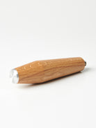 A bottomless Pesado portafilter with a Specht oak, stainless steel end-capped handle.